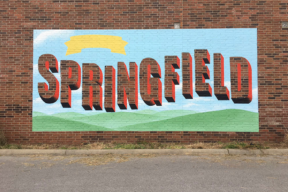 Artist Andrea Ehrhardt is preparing a "Greetings from Springfield" mural on the brick wall of the Discovery Center.