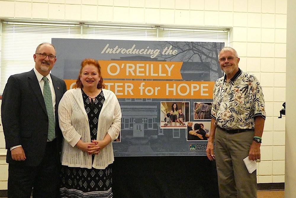 Outgoing Springfield City Manager Greg Burris, left, CPO CEO Janet Dankert and Charlie O’Reilly unveil the O’Reilly Center for Hope name for a community hub at the former Pepperdine Elementary School.