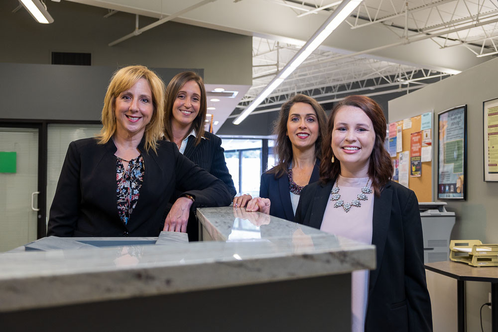 From left, Sherry Coker, Sara Coatney, Cary Charles and Breanna O’Bryan make up part of the team at Ozarks Technical Community College Center for Workforce Development, which has partnered with more than 100 businesses and organizations over the past three years.