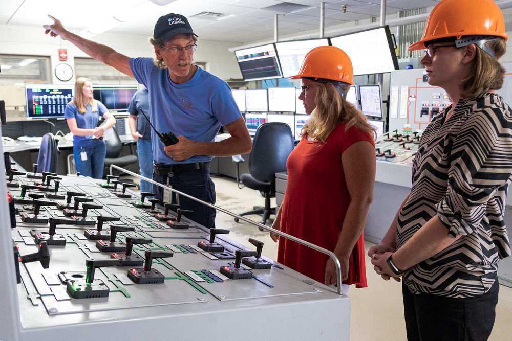 ENERGIZING TOUR: Kent Potts of City Utilities explains the control room operations at the John Twitty Energy Center to teachers Kelly Prude, center, and Tiffany Lindley. The teachers are part of an externship program.