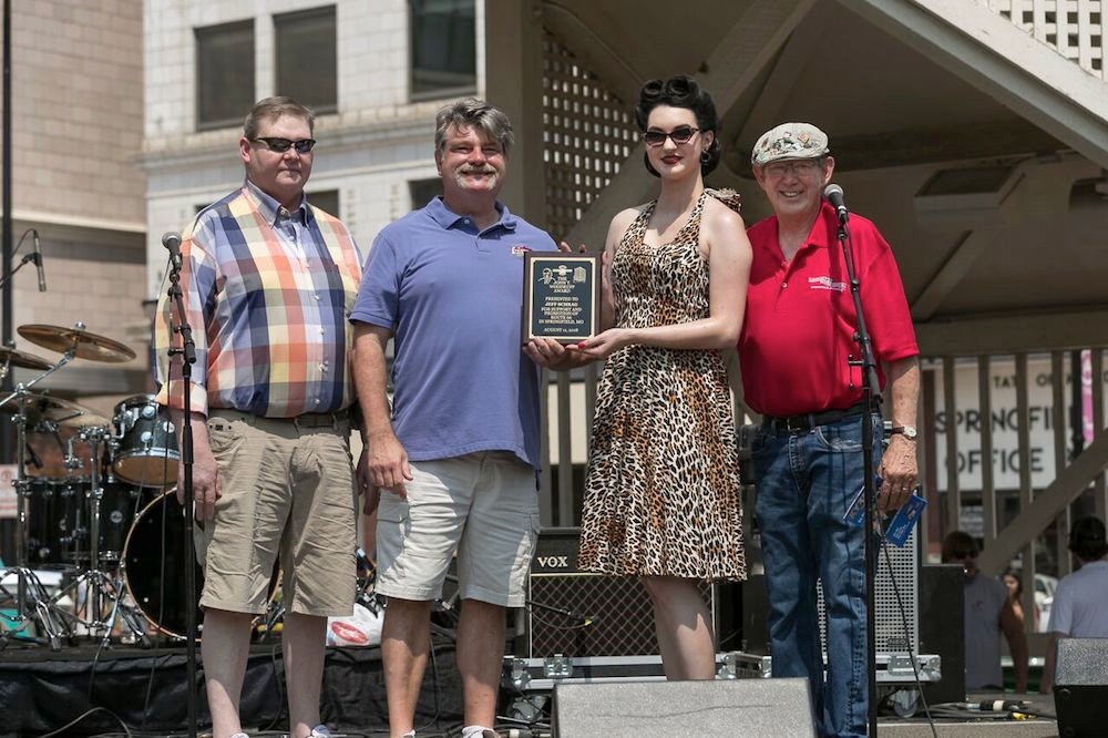 Jeff Schrag, second from left, receives the John T. Woodruff Award. He’s joined by Woodruff’s grandson, John T. Woodruff III, left, and Birthplace of Route 66 Festival co-founder David Eslick, right.