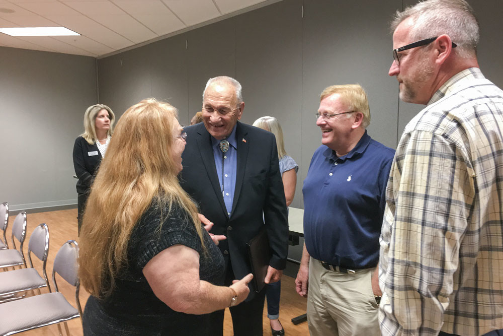 Change One Thousand graduate Marjorie McCormack, left, visits with Greene County Commissioner Harold Bengsch and Springfield Mayor Ken McClure.