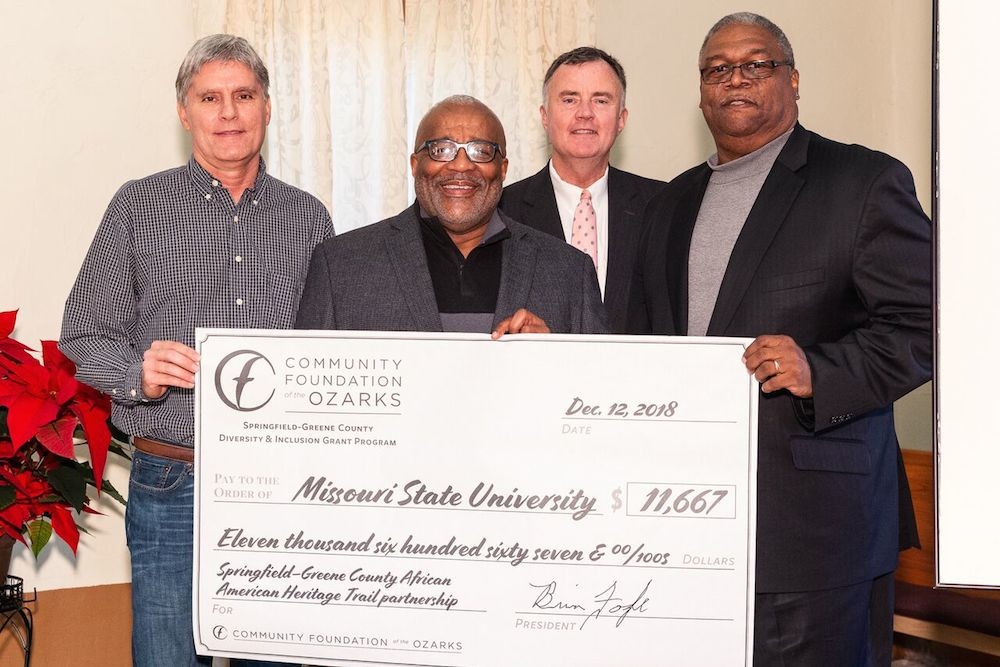 CFO President Brian Fogle, second from right, presents a check to Tim Knapp, left, Lyle Foster and West Pratt, right.