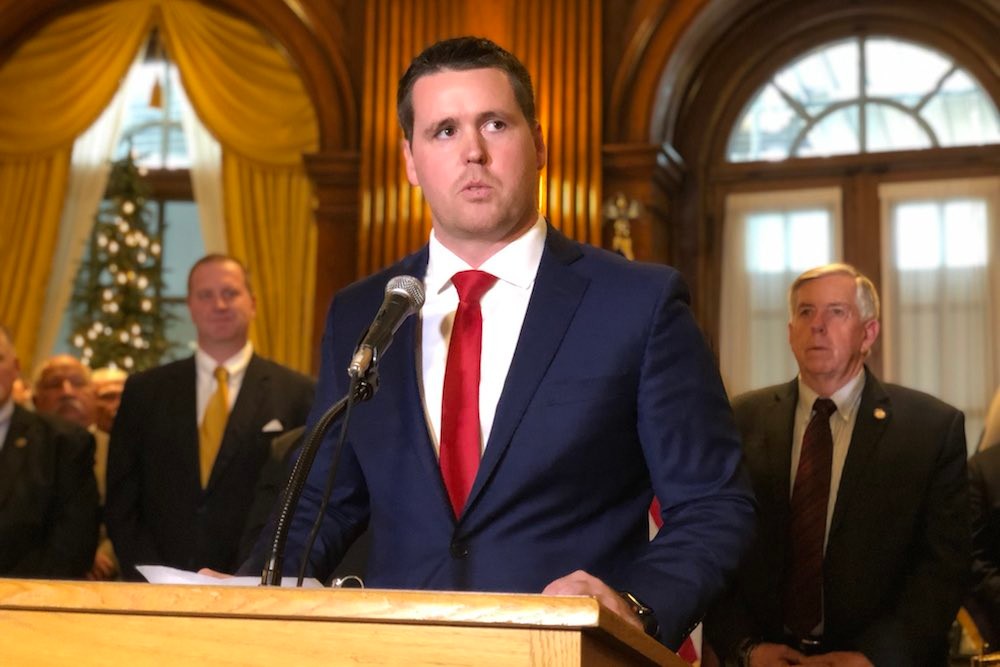 Scott Fitzpatrick, flanked by Gov. Mike Parson, right, and outgoing Treasurer Eric Schmitt, left, speaks at a ceremony announcing his new position.