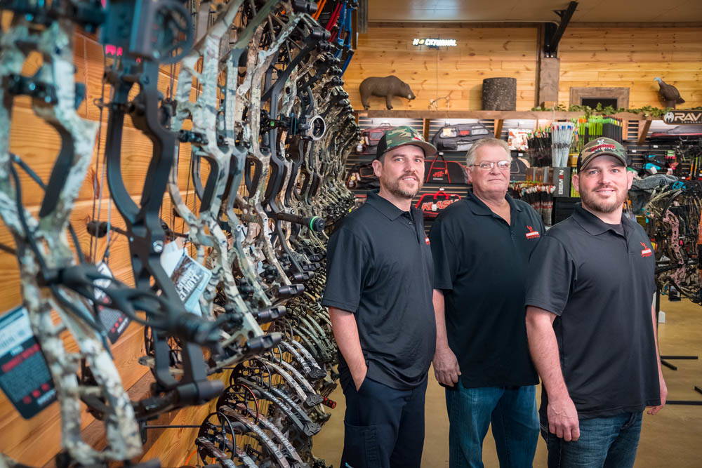 BOWS ABOUND: Midwest Archery’s brick-and-mortar store north of town is the first for the Williams family, left to right, Jason Greg and Brad.