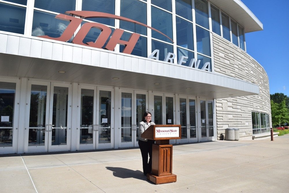 Suzanne Shaw, vice president for marketing and communications at Missouri State University, announces signage removal plans at the main entrance to JQH Arena.