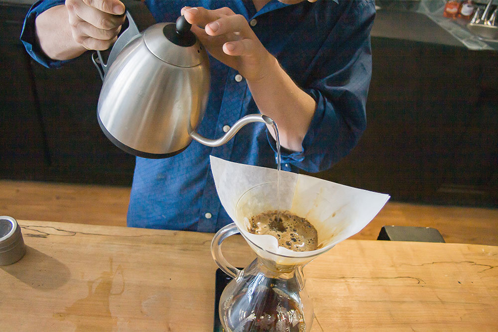 Rance Loftsgard prepares a single-origin, pour-over coffee using beans from El Salvador roasted by Elixr Coffee.