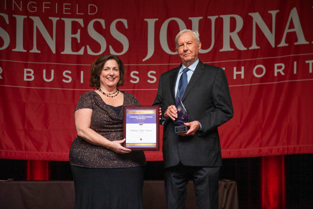 William “Bill” Turner accepts the 2019 Lifetime Achievement in Business Award from Springfield Business Journal Publisher Jennifer Jackson.