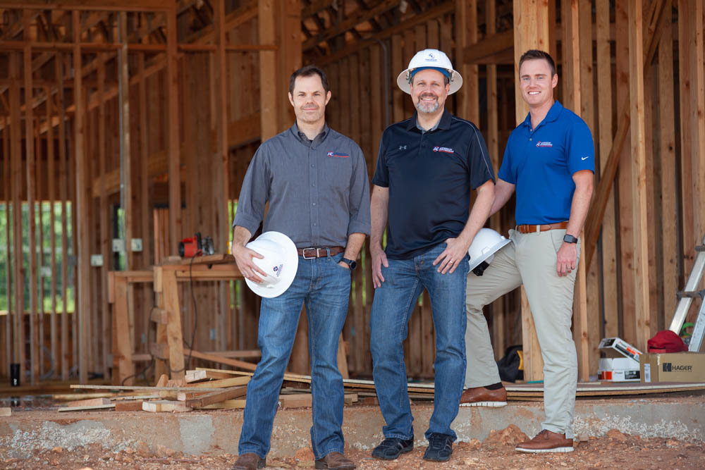 FRESH DIGS: From left, Aaron Hargrave, Paul Engel and Jared Davis of Anderson Engineering Inc., expect construction on its new headquarters to wrap by December.