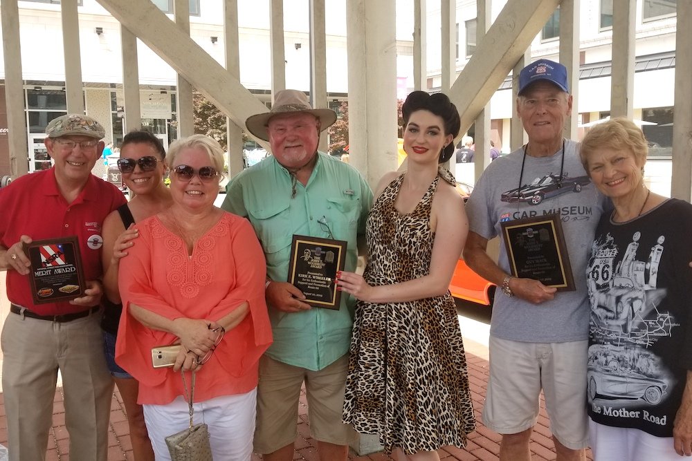 Kirk Wheeler, fourth from left, and Guy Mace, second from right, receive the John T. Woodruff Award. They’re joined by family members and Miss Birthplace of Route 66 Sarah Vega, third from right.