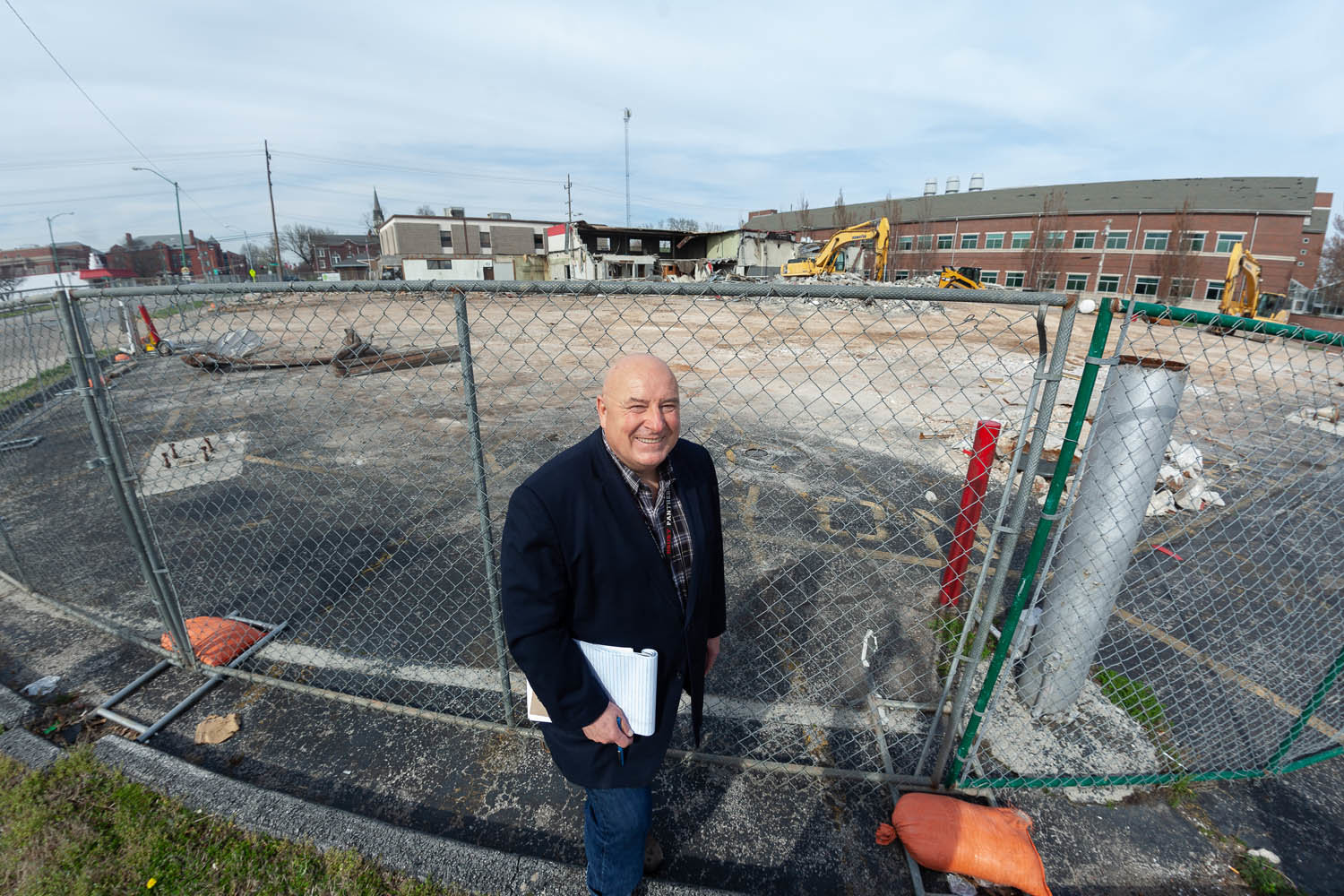 Drury University executive David Hinson stands at the corner of Benton Avenue and Chestnut Expressway, where the school razed buildings for future expansion purposes.
