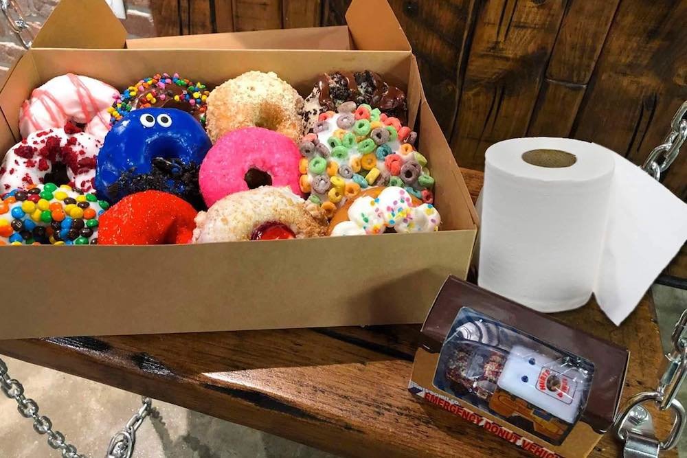 Hurts Donut is offering a roll of toilet paper with a dozen doughnuts.