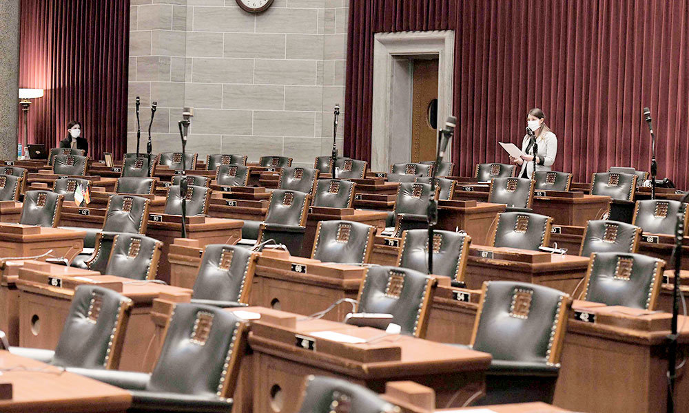 DISTANT LEGISLATING: Rep. Crystal Quade, D-Springfield, speaks at a nearly empty Missouri House of Representatives session April 8, in which legislators approved a $6.2 billion COVID-19 relief plan.
