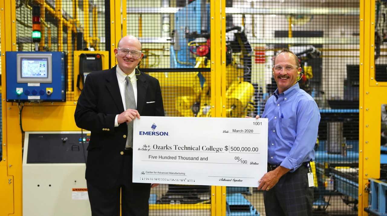 OTC Chancellor Hal Higdon, left, accepts the gift from Emerson Director of Operations Keith Calhoun.