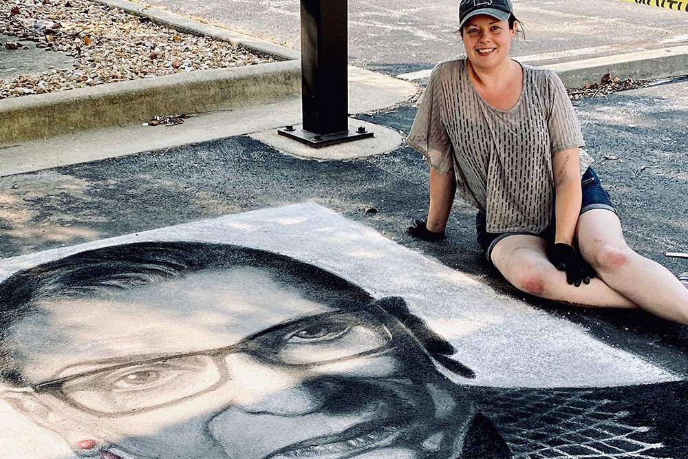 RIP RBG
Obelisk Home Gallery Manager Christie Snelson, above, on Sept. 20 creates a memorial chalk drawing of Supreme Court Justice Ruth Bader Ginsburg, who died Sept. 18. She said the 6.25-by-9.75-foot drawing, located in the downtown home decor store’s west parking lot, took her seven hours to complete. Snelson has created memorial drawings of influential people in the past. Speaking on RBG’s influence, Snelson said, “She had an immeasurable impact on my life because of rights she sought for women.”
