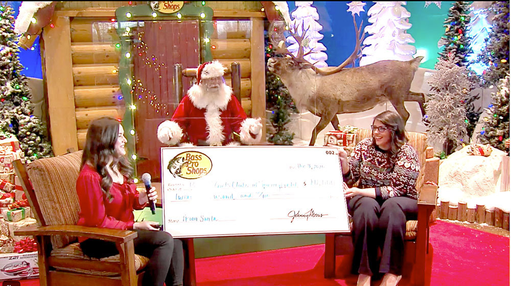 GOOD MORNING GIFTBoys & Girls Clubs of Springfield CEO Brandy Harris, right, receives a surprise $20,000 donation during the Springfield Area Chamber of Commerce’s final Good Morning, Springfield event of the year. Sarah Hough, Bass Pro Shops community affairs manager, left, and a staffer dressed as Santa Claus presented the check during the Dec. 3 livestream.