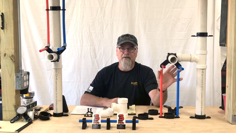 3D&L owner Doug Harris demonstrates the company's products that hold pipes in place.