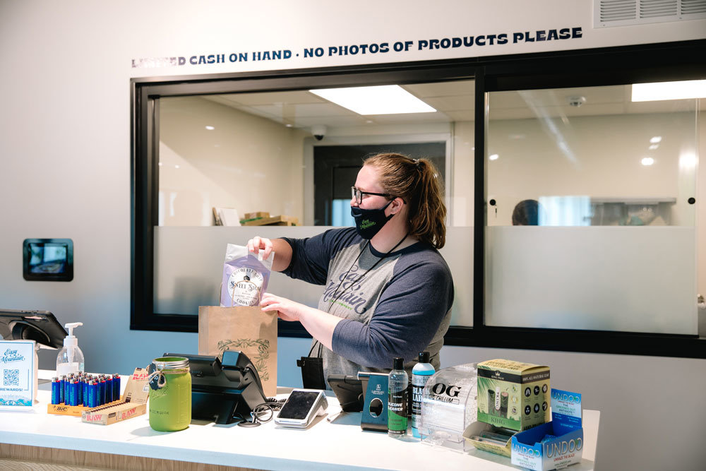 BAKED ORDER: Easy Mountain Cannabis employee Shelby Blakley packages an order of Heartland Labs' cannabis-infused chocolate chip cookies.