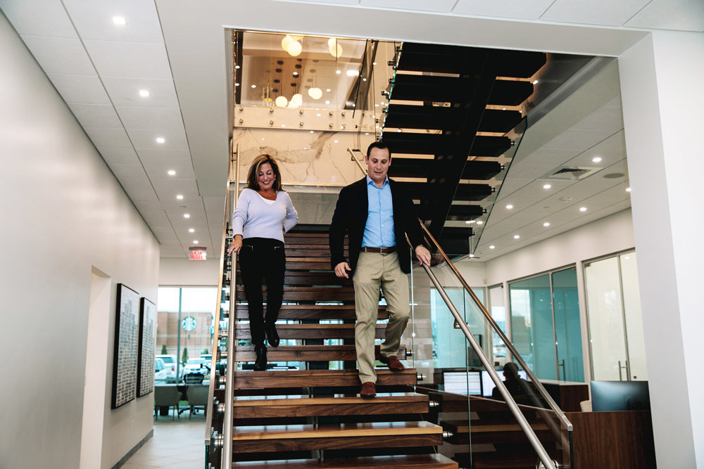 Magers and receptionist Angela Hayes walk down the centerpiece staircase on the first floor. An elevator leads to the fourth-floor executive offices, where Magers says “50%-60% of the business happens,” and corner offices feature floor-to-ceiling glass walls. Base Construction & Management LLC built the HQ on budget under $200 a square foot.