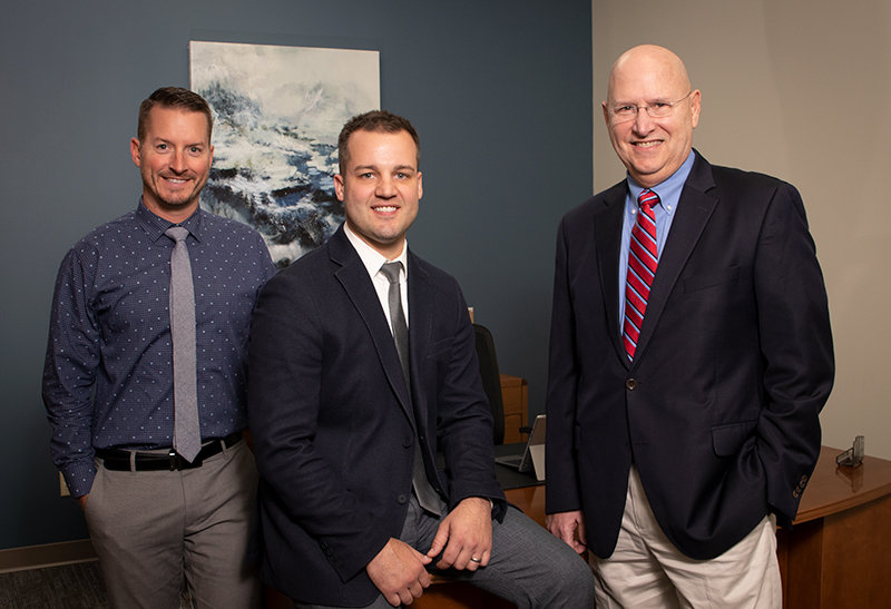 Pictured L-R:  Matt Woessner - Vice President, Shane Crawford - Broker/Manager, Mike Woessner - President