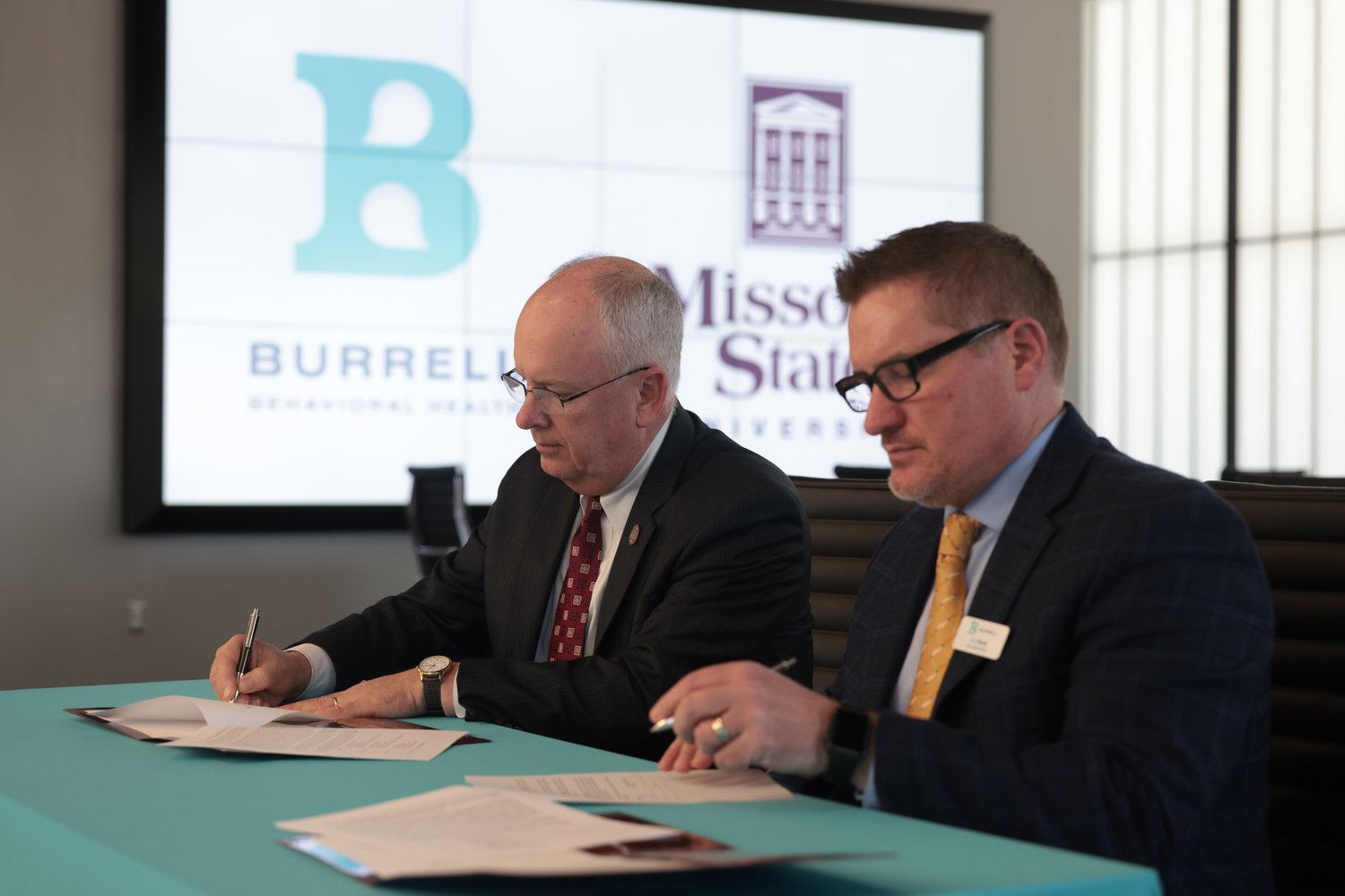 MSU President Clif Smart, left, and Burrell President and CEO C.J. Davis sign a memorandum of understanding.