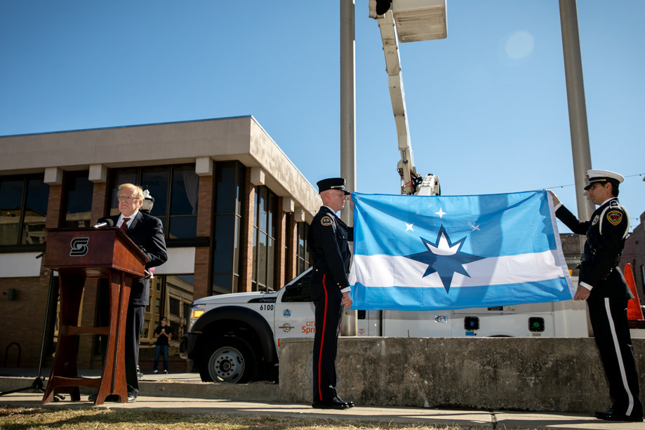 City officials install the new flag during a March 1 ceremony at Park Central Square.