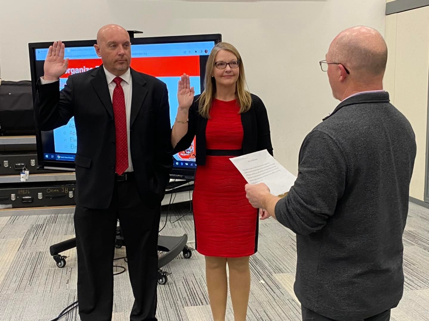 Mark Jenkins and Sarah Adams Orr are sworn in during a recent school board meeting.