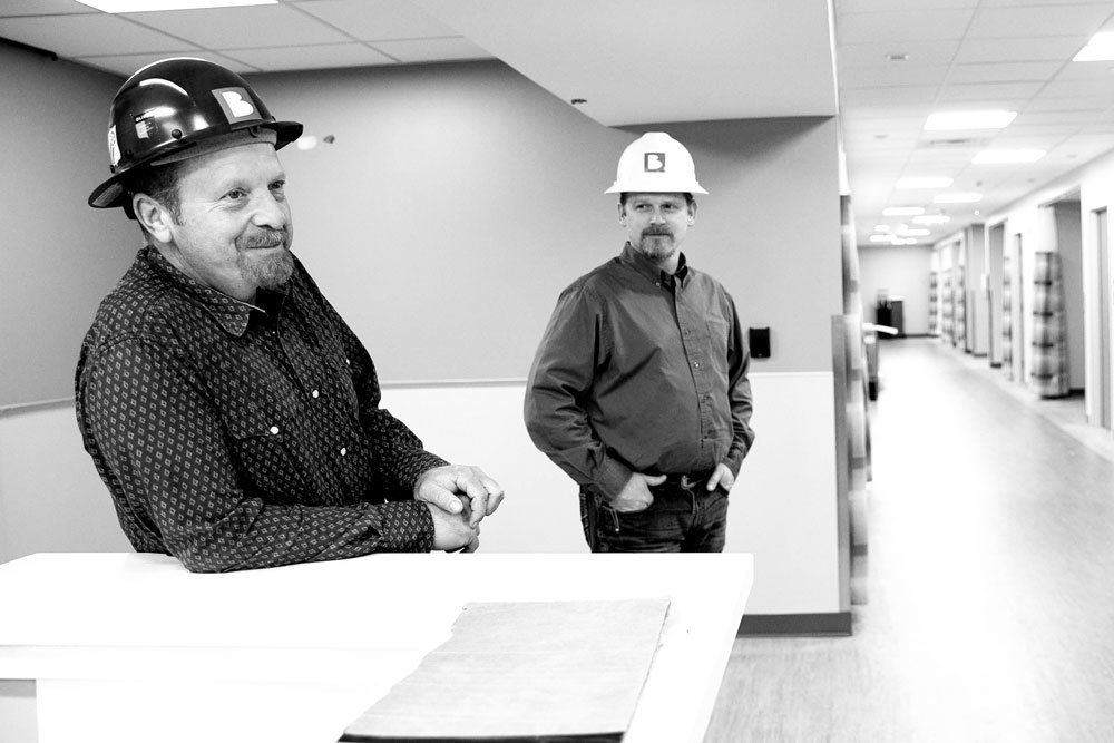 HEALTH VISIT: Sean Thouvenot discusses ongoing work with Project Manager Mike Coan during a site visit at Jordan Valley Community Health Center's new clinic and Ambulatory Surgery Center.