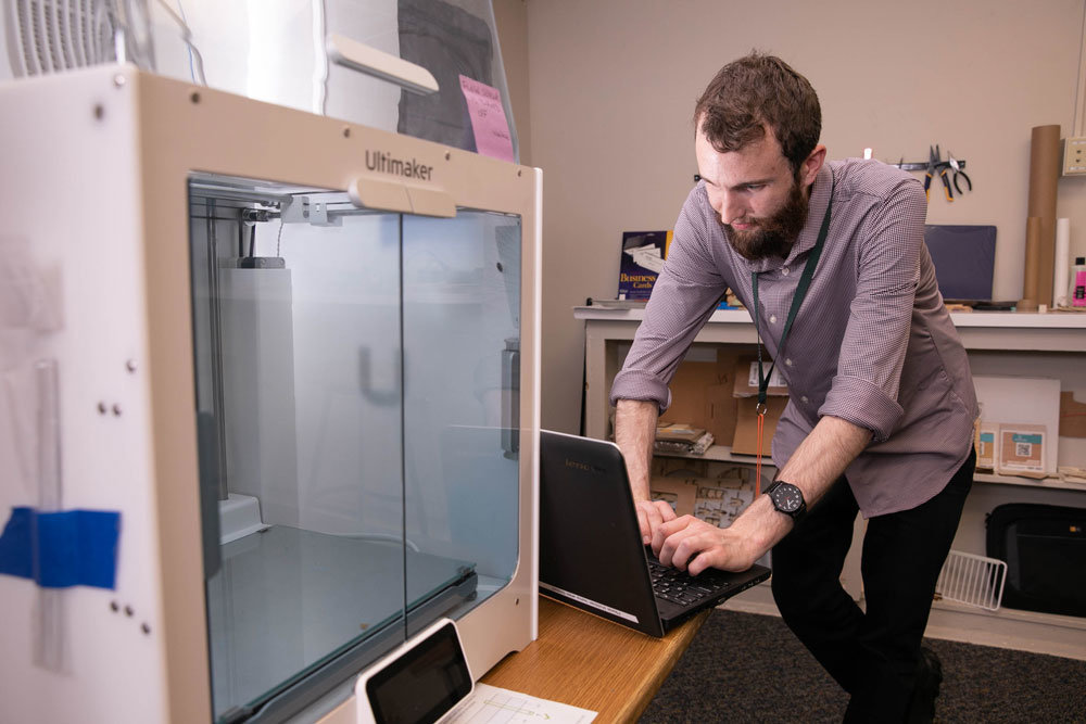 MAKER SPACE: Jacob Helterbrand, training assistant at the Midtown Carnegie Branch Library, demonstrates 3D printing capabilities available to the public.