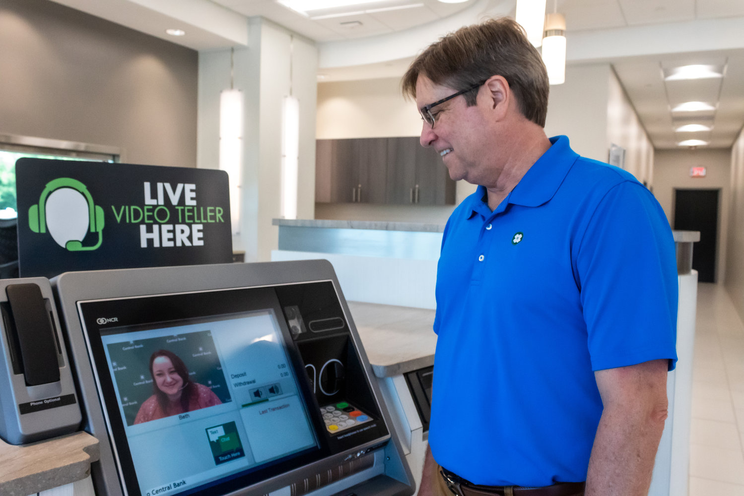 Andrew Tasset of Central Bank in Springfield converses with Columbia-based teller Beth Burkett via one of nine video teller machines in the area.