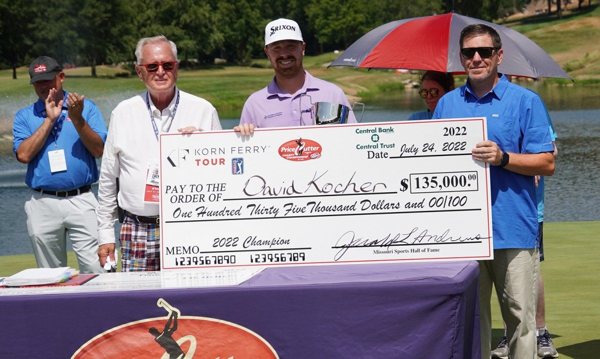Outgoing PCCC Executive Director Jerald Andrews, left, and Price Cutter executive Rob Marsh, right, present a check to tournament winner David Kocher.