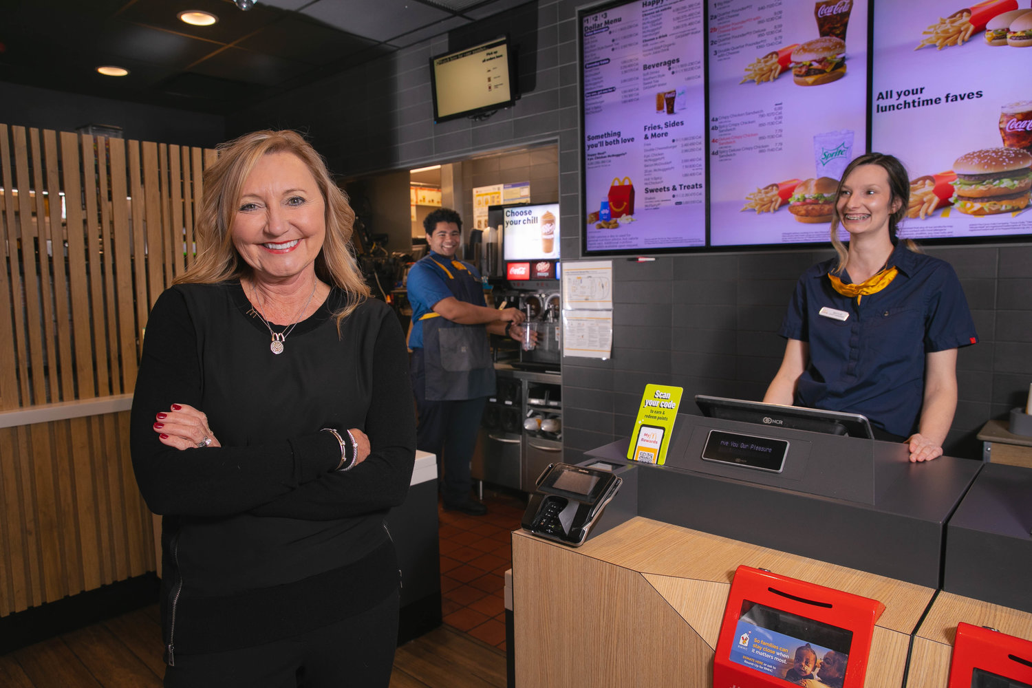 Missouri's recent minimum wage hike happened simultaneously with a worker shortage that drove up pay. McDonald's co-owner Teresa McGeehan, left, says compression was the big complication for her company.