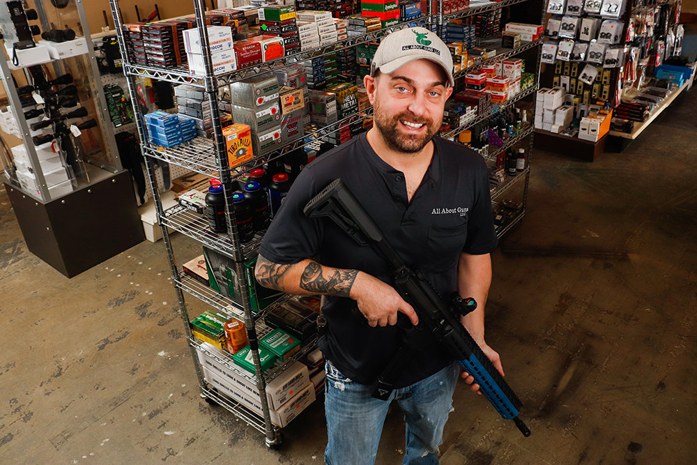 LOCKED AND LOADED: T.J. Taylor, co-owner of All About Guns, carries merchandise ranging from antique firearms to the latest technology in guns and accessories.