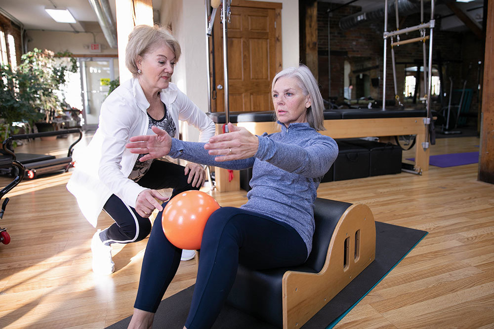 Shelley Hampton, left, trains a client at her Shape Shifters Pilates studio in a 130-year-old building at National Avenue and Chestnut Expressway.