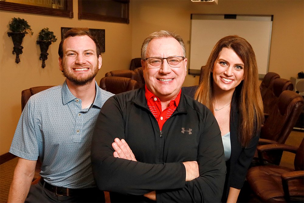 Ken Stephens, co-owner of Employee Benefit Design, says he enjoys working with two of his children, Drew Stephens, left, and Kimberlee Nevins, right, possible successors for the company.