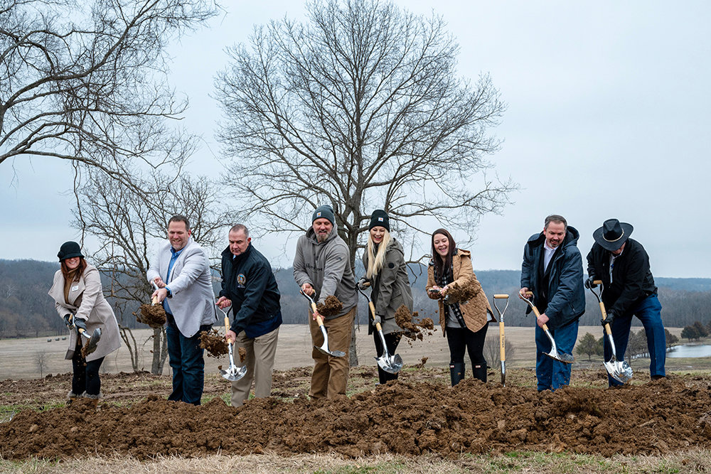 Dignitaries including Missouri Lt. Gov. Mike Kehoe, third from left, and Sparta Mayor Jenni Davis, third from right, join Chad and Tiffanie Shook in breaking ground for Finley River Outpost off State Highway 125 in Sparta.