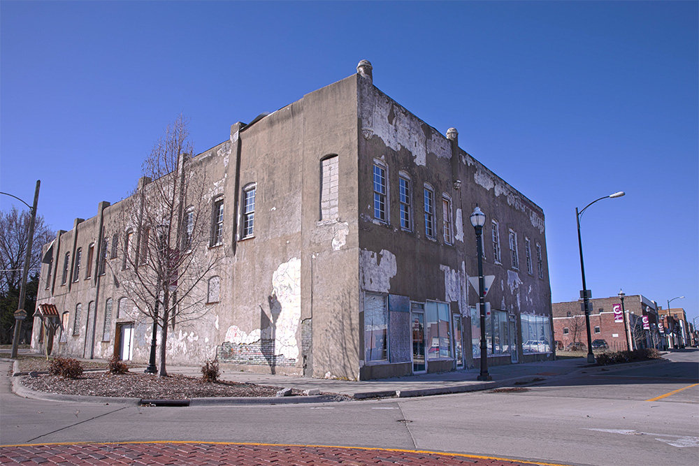 COMING DOWN: Developer Titus Williams plans to raze this structure at 536-540 E. Commercial St. it is a brick structure covered by stucco at some point in its history.