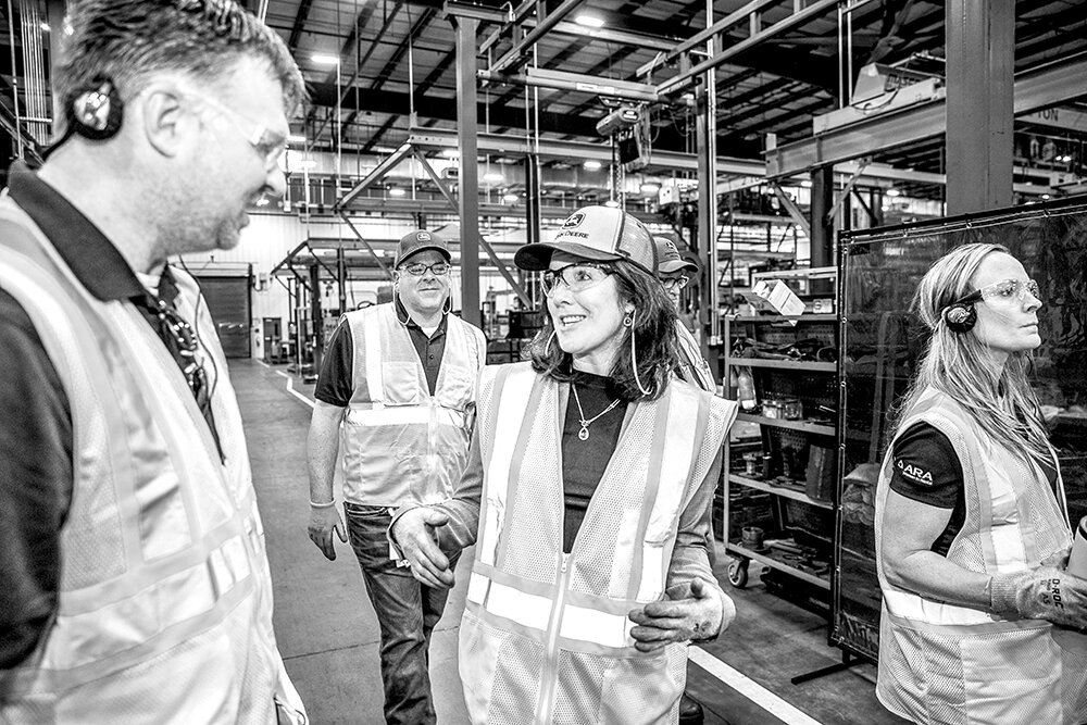 WALK THE LINE: At the Strafford John Deere Reman facility, Jena Holtberg-Benge connects with guests from an out-of-town group of John Deere employees, most of whom say the company's remanufacturing facilities for the first time.