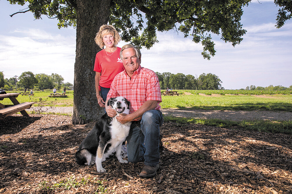 BOOTS TO BERRIES: Johnelle and Randy Little, the former owners of PFI Western Store, are in their first season at the helm of Missouri Berry Farm with their dog, Jed, a retired rodeo performer.