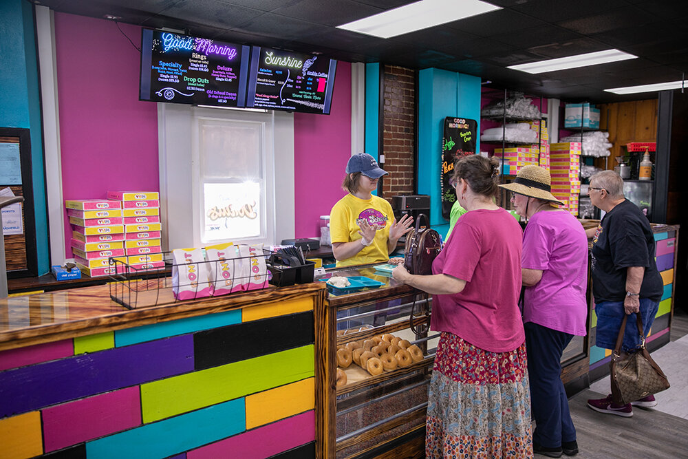 Customers are assisted at Old School Donut Shop, which opened last month in former school classroom space.