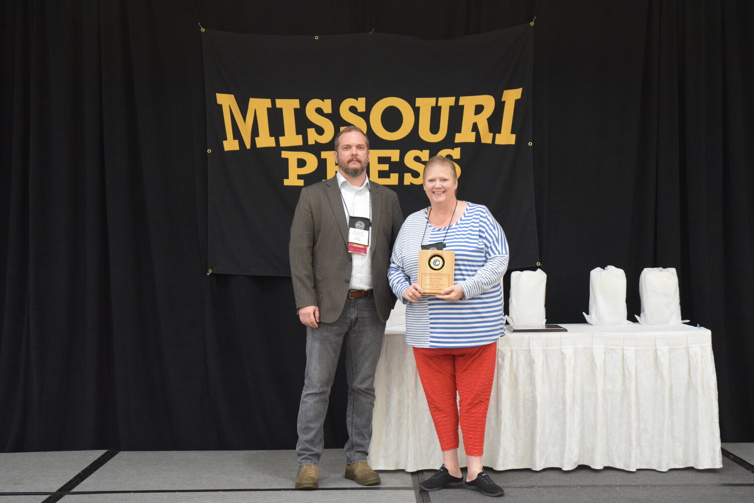 Acting Missouri Press Association board President Amos Bridges, of the Springfield News-Leader, presents SBJ reporter Karen Craigo with one of its 26 individual honors.