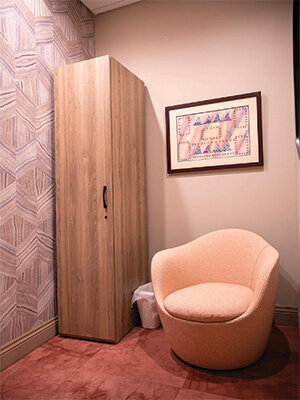 Coordinated Effort: Amanda Lackey knew she was doing something right when she brought in a set of paintings from her parents’ collection, and they coordinated perfectly with the textured wallpaper, rose-colored carpet and peach barrel chair of the dressing rooms designed by Grooms’ Alissa Lacamp.
