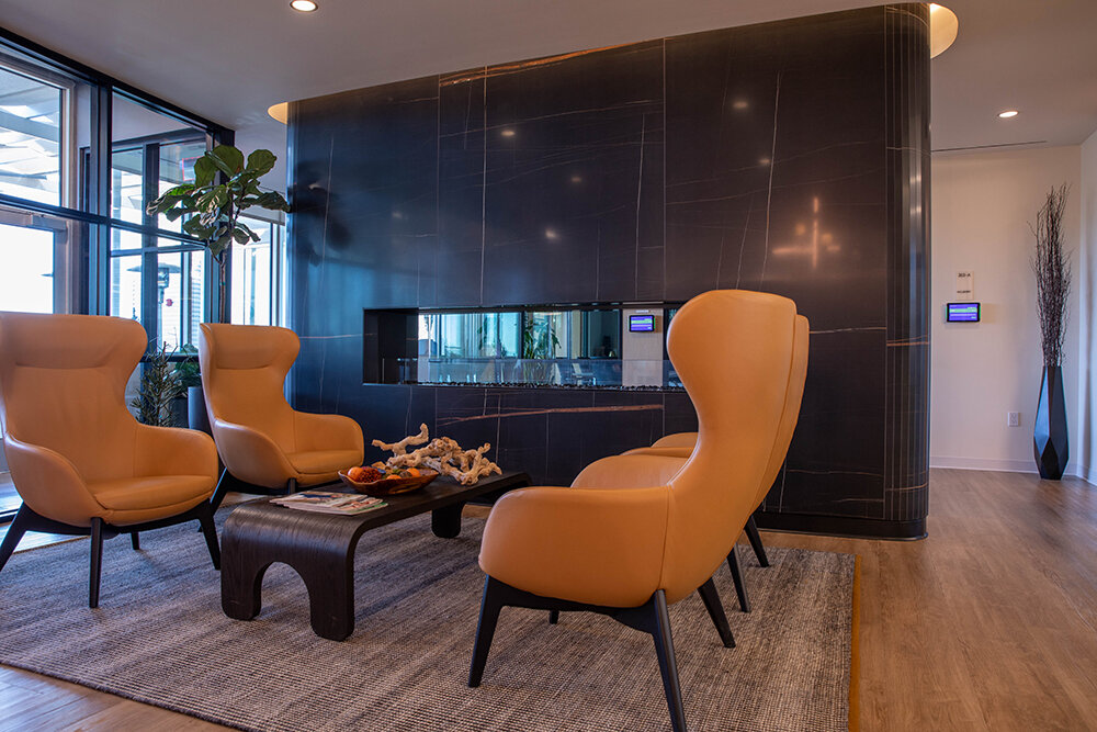 High Impact: A dual-sided fireplace brings the wow factor to the Husch Blackwell lobby, with a mixture of carpet, tile and wood flooring used throughout the space.