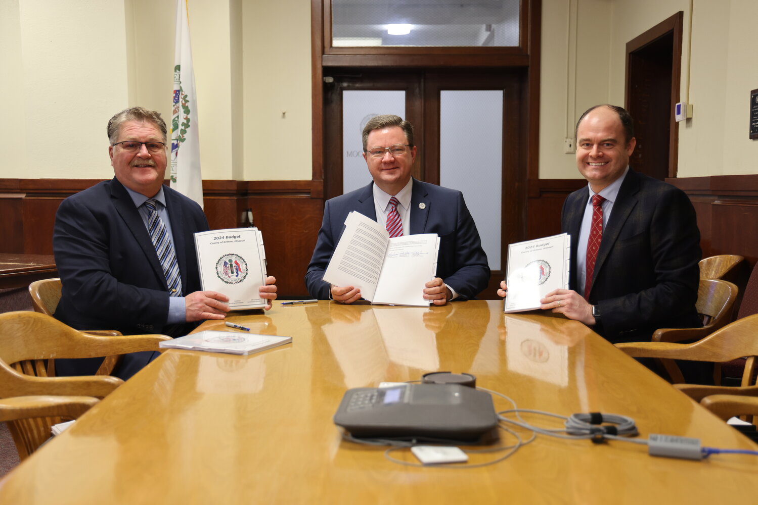 From left, Greene County Commissioners Rusty MacLachlan, Bob Dixon and John Russell sign the 2024 spending plan for county government.